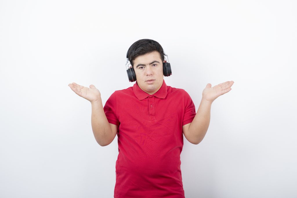 young man standing music wireless earphones